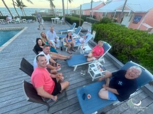 Blue Horizon divers relaxing on sun loungers by the pool at Little Cayman Beach Resort